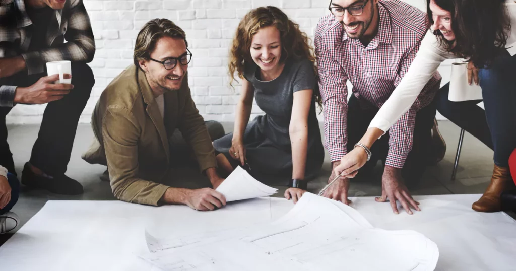 employees looking at paper