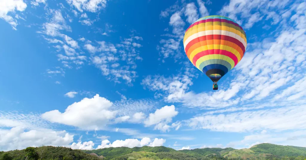 a hot air ballon over a field