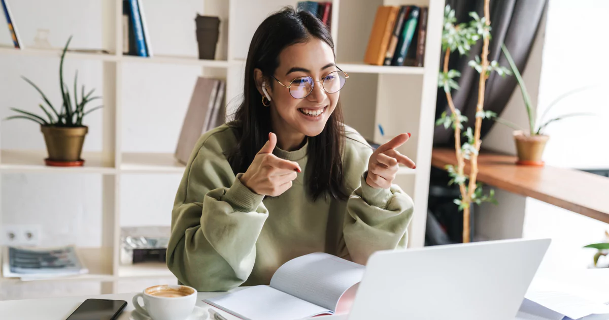 smiling-finger-point-woman smiling woman laptop finger point glasses