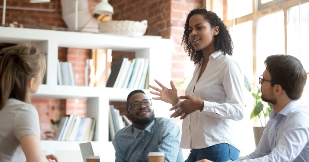 woman-leader-office-team-curly-hair-button-up